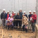 University of MD students pose for a photo with rocks that they excavated