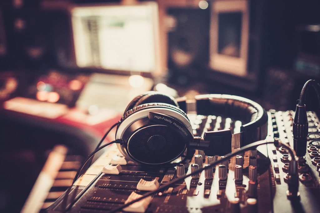 Headphones sitting on an audio mixer